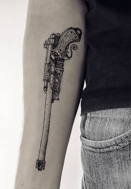 Men Showing Her Right Lower Arm Dotwork Old Big Gun Tattoo